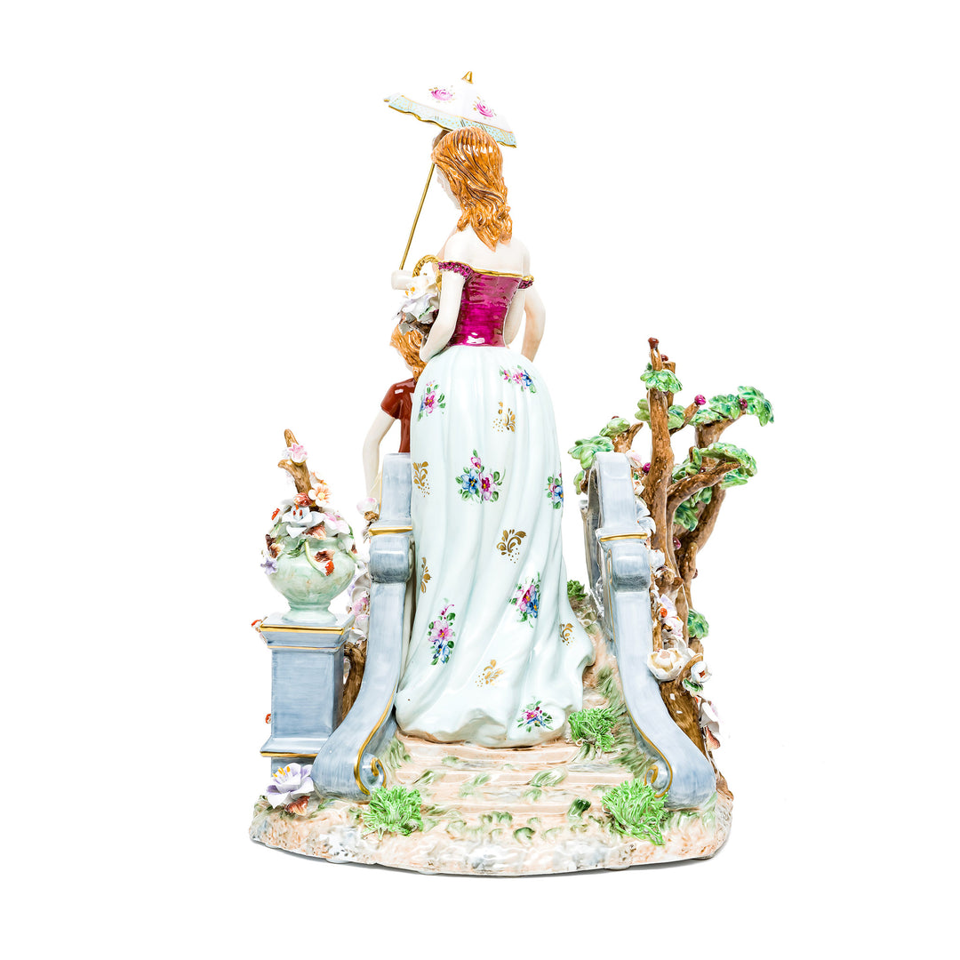 Hand-painted porcelain figurine with delicate floral patterns and pastel colors.