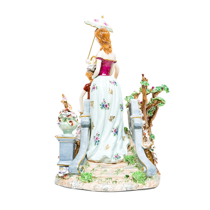 Hand-painted porcelain figurine with delicate floral patterns and pastel colors.