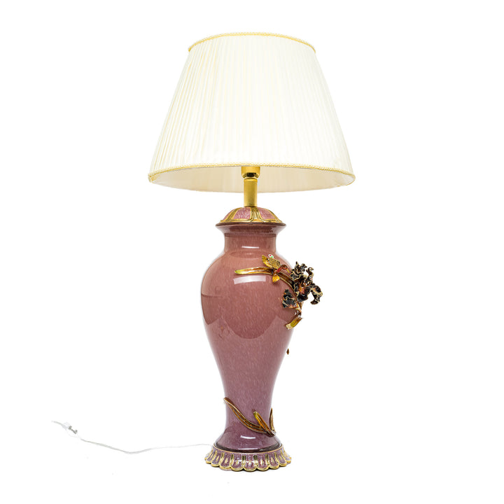 Lavender table lamp with golden floral embellishments.