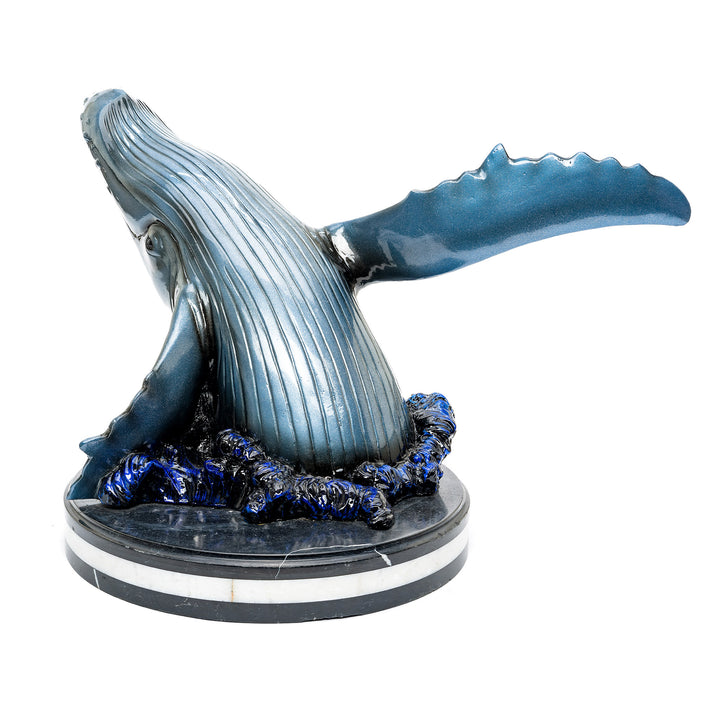 Lifelike bronze whale art piece capturing marine grace and strength.