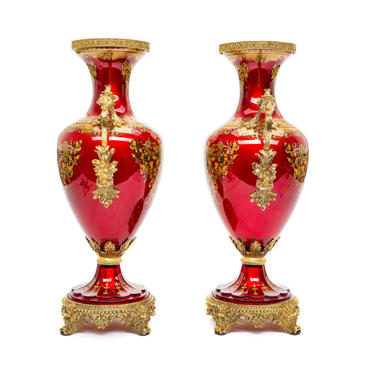 Luxurious pair of crystal vases with deep red glaze and gold accents.
