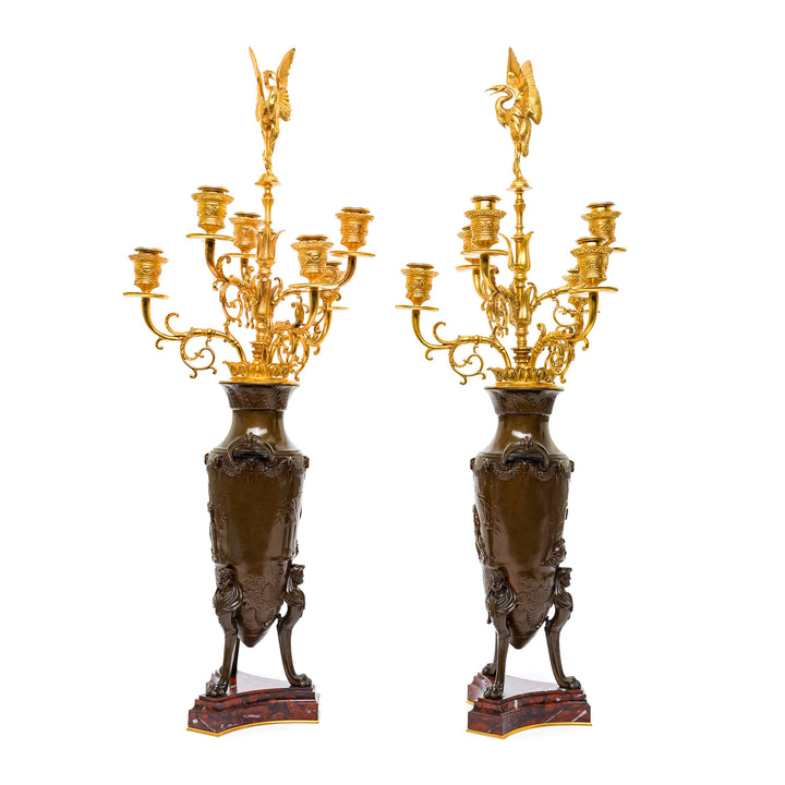 Luxurious urn-shaped bronze candelabras with gold accents.