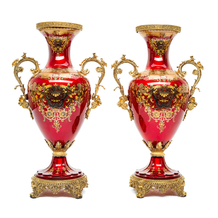 Opulent red crystal vases with ornate bronze base and luxurious detailing.