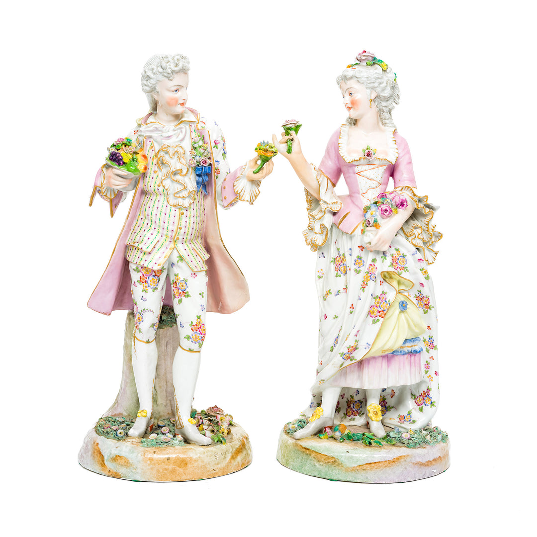 Romantic Rococo Courtiers porcelain figurines in elegant period attire.