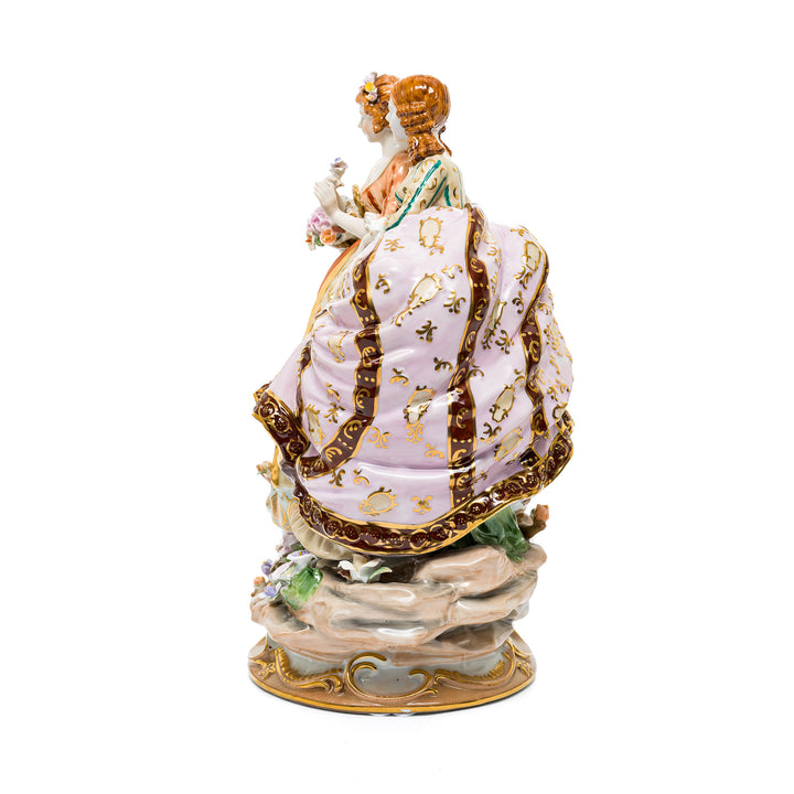 Vibrant Dresden porcelain figurine with intricate floral details.