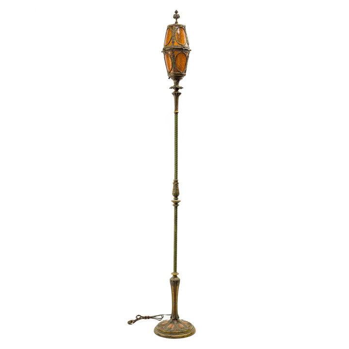 Antique amber glass floor lamp with ornate metalwork and elegant base