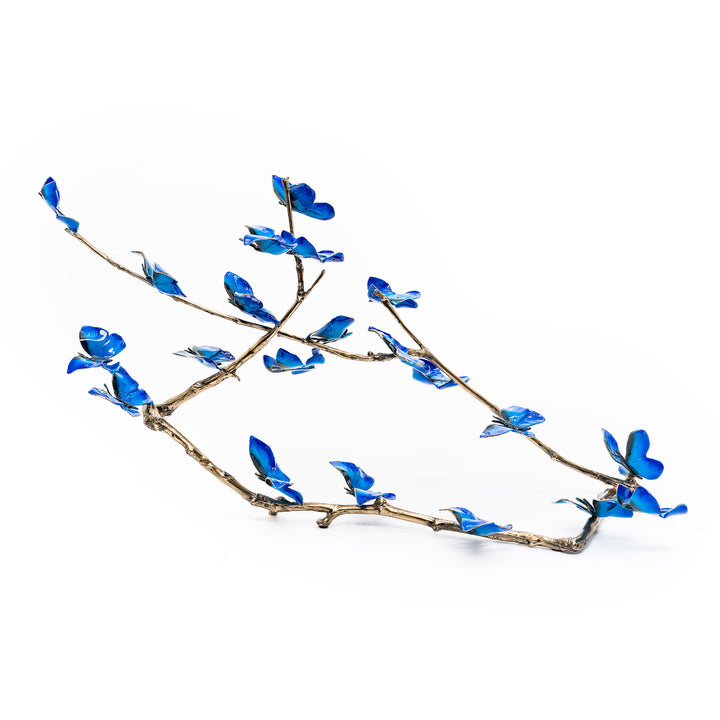 Rear profile of blue butterfly installation with golden branch
