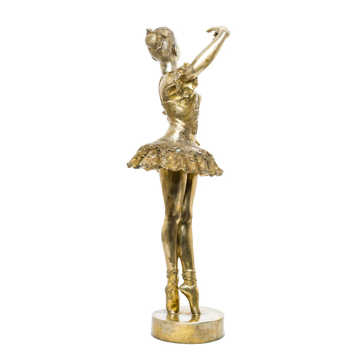 Bronze ballerina on pointe with extended arms and silver patina.