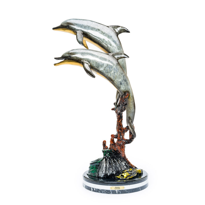 Two bronze dolphins leaping above a coral-inspired base with custom patinas