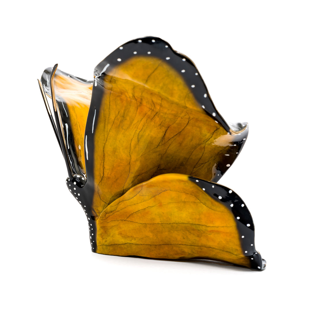 Monarch butterfly in bronze with black and white dotted border