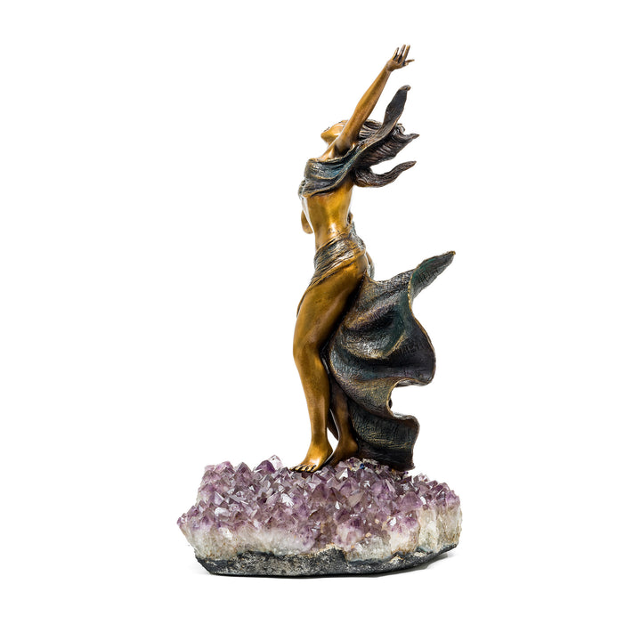 Side view of bronze figure reaching upward atop crystal base