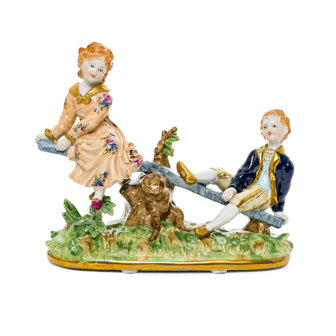 Porcelain figurine of children playing on a seesaw, made from fine German porcelain.