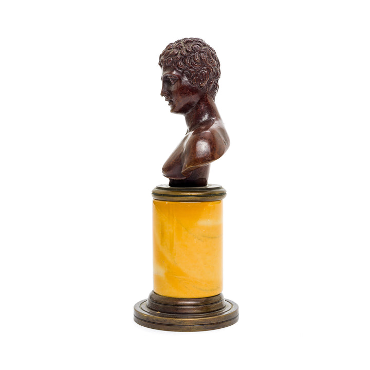 Classic Italian bronze bust sculpture with an amber marble column base, highlighting refined details.