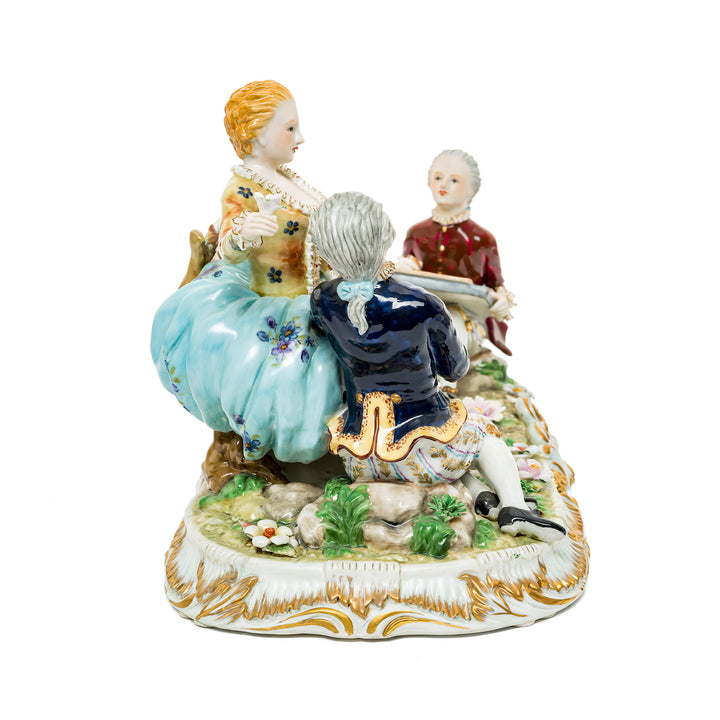 Collectible German porcelain courting trio figurine with elegant hand-painted designs.