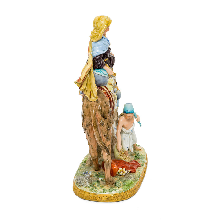 Desert Journey porcelain figurine depicting a traveler on a camel and a boy gathering water.