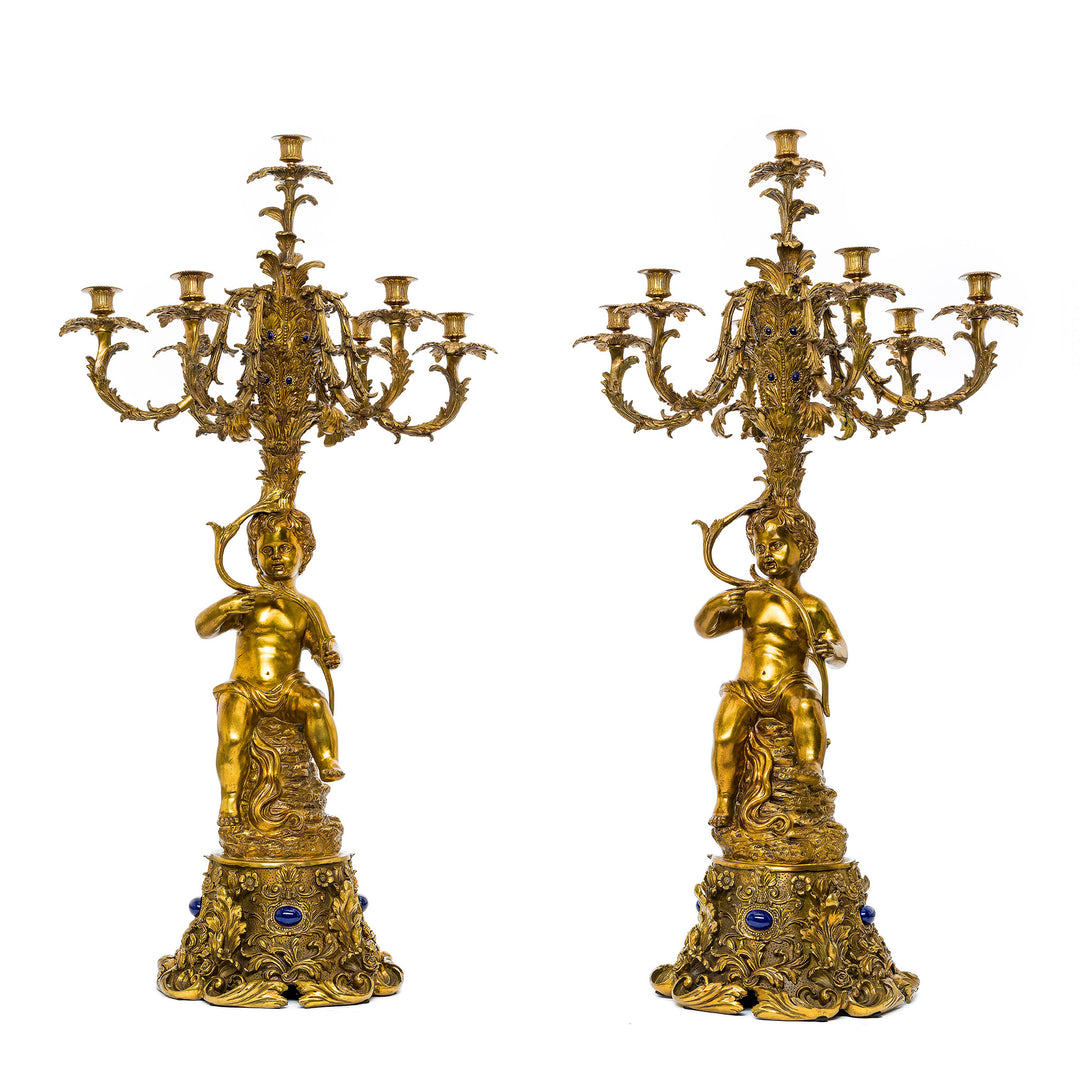 Pair of ornate Dore bronze candelabras with cherub figures and floral details