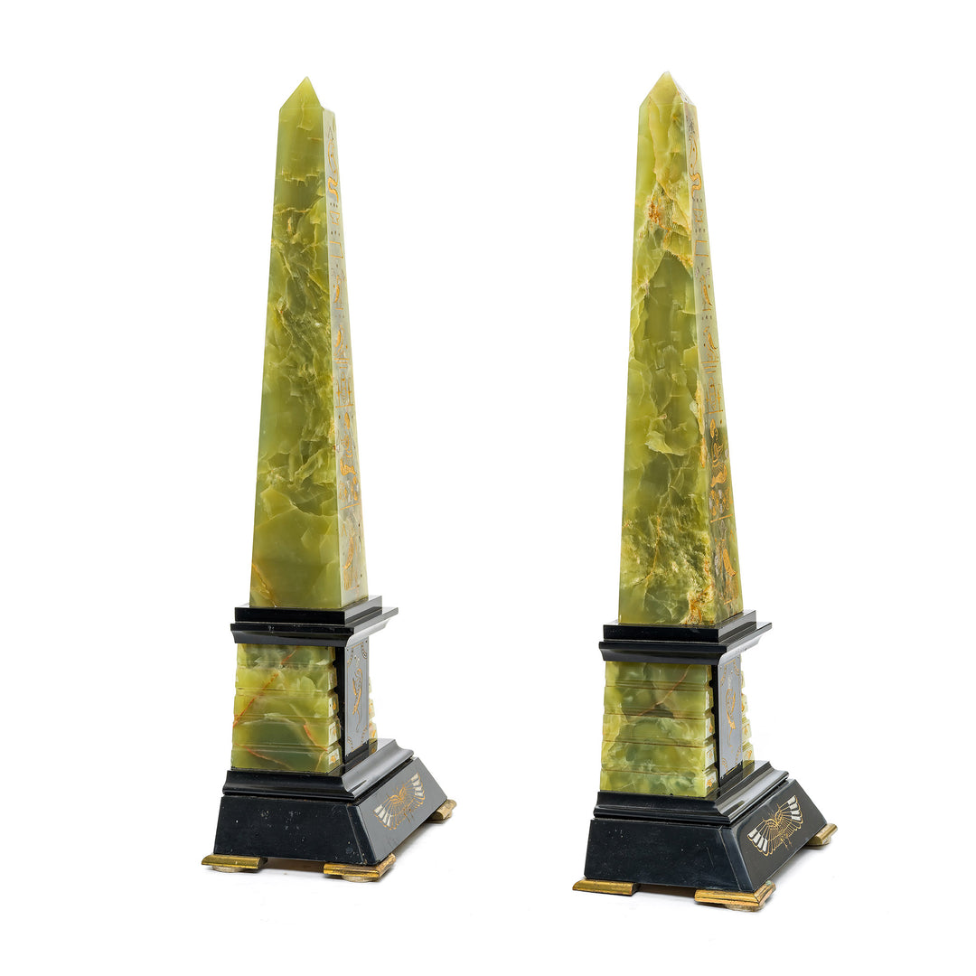 Egyptian-inspired onyx obelisks with gold hieroglyphics and black marble base.