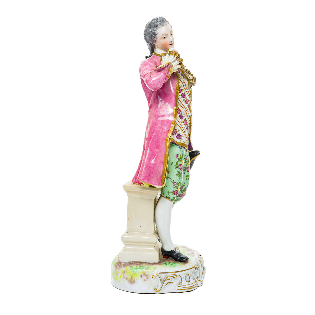 Elegant German porcelain figurine of a Rococo gentleman, hand-painted with detailed floral patterns and gold accents.