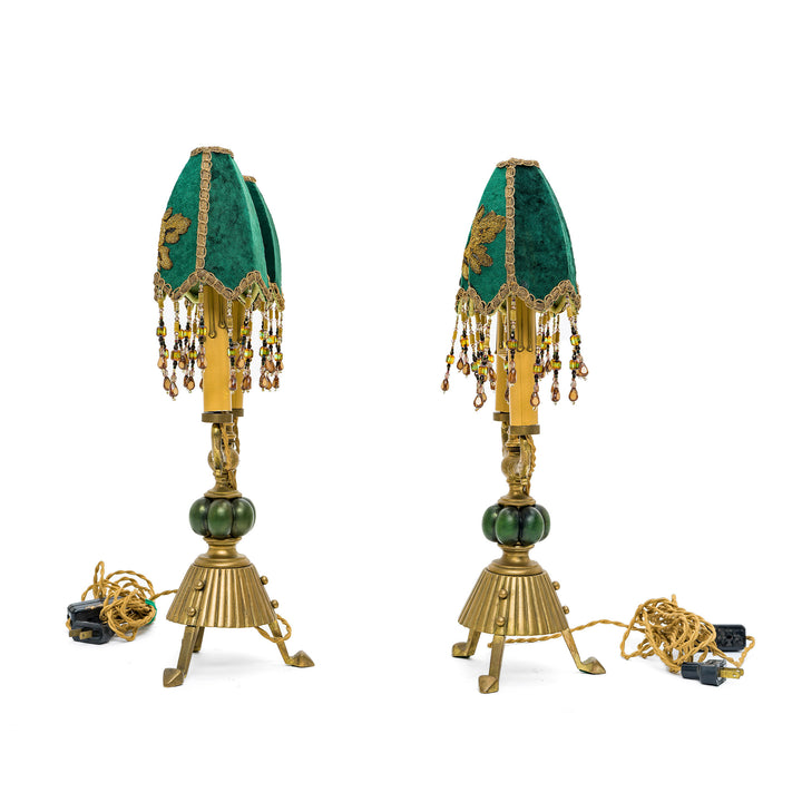 Elegant Victorian-style lamps with ornate bronze bases and beaded fringe