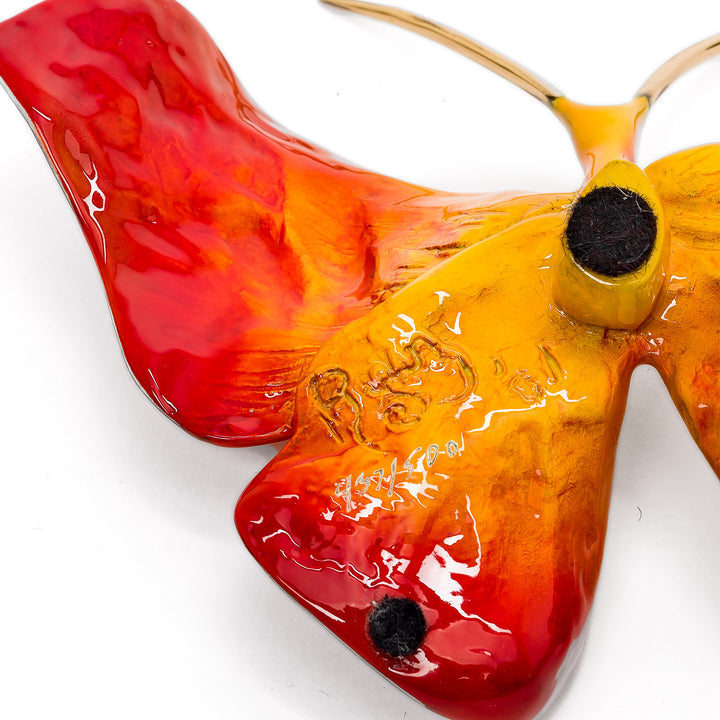 Glazed enamel butterfly figurine with red-orange hues
