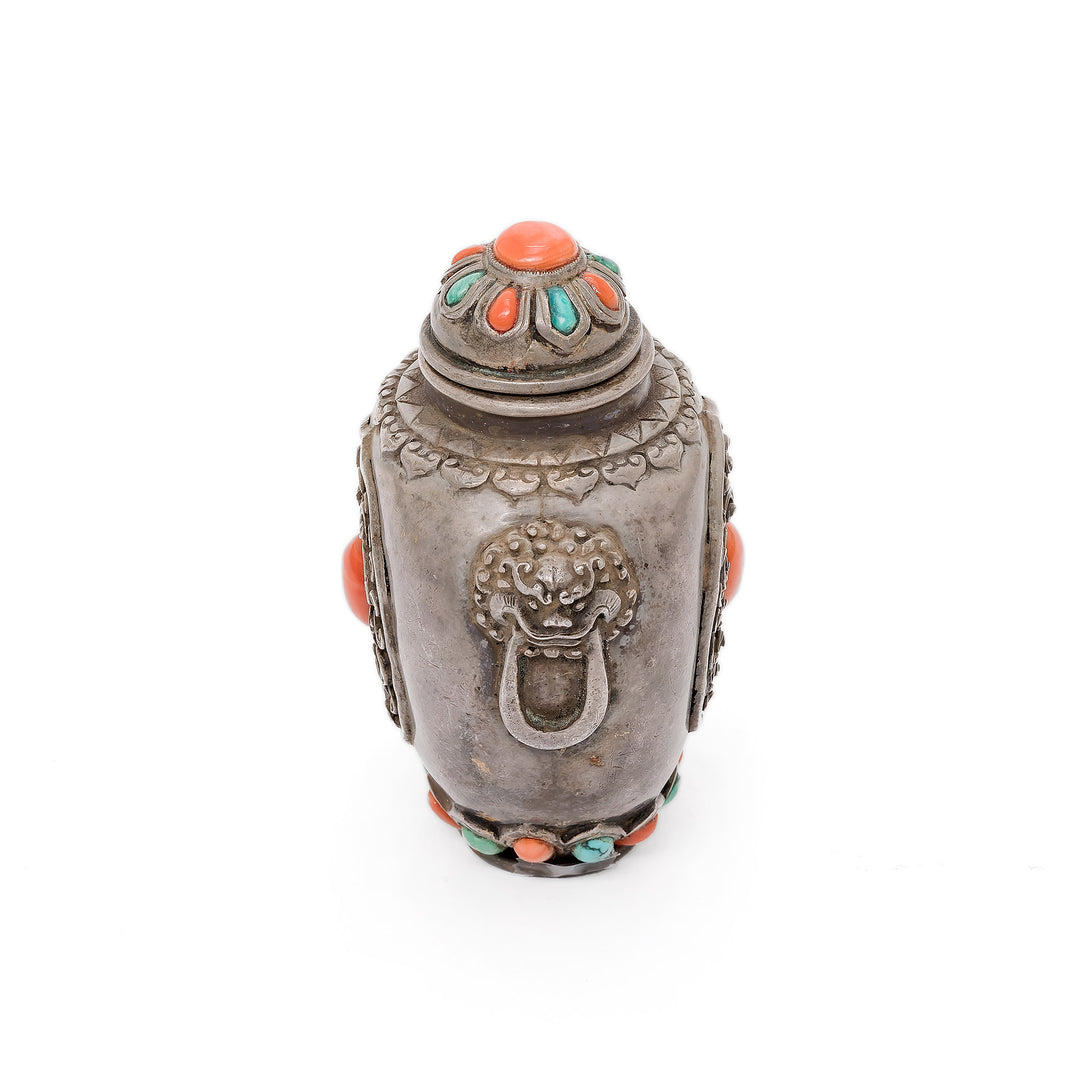 Top-down view of ornate silver stopper with gemstone embellishments