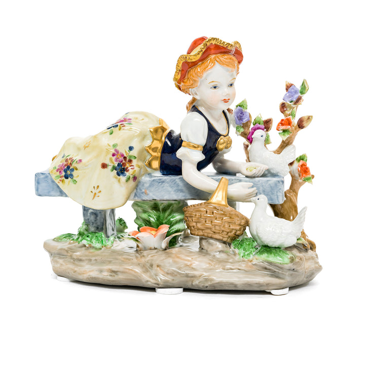 Gentle Moments with Nature German porcelain figurine featuring a young girl feeding doves.