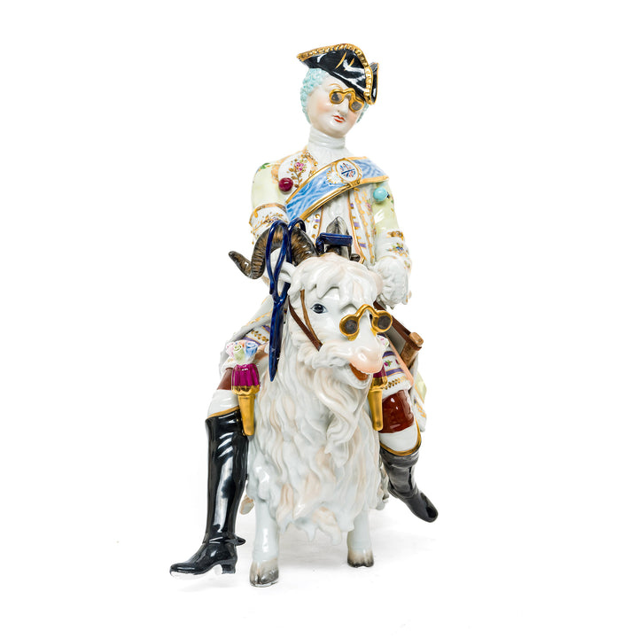 German porcelain figurine of a nobleman riding a goat, showcasing intricate hand-painted details.