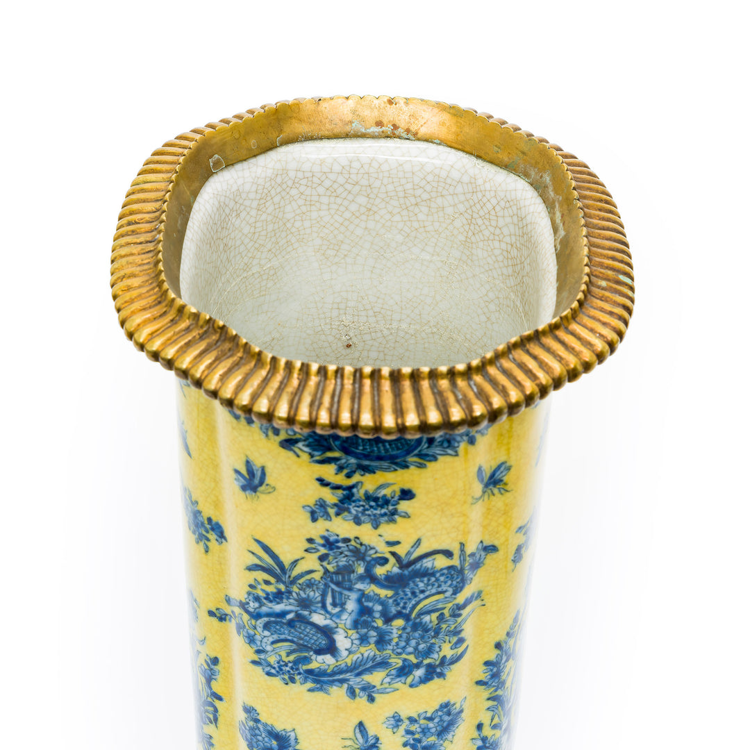 Detail of ribbed gilt metal rim on porcelain vase