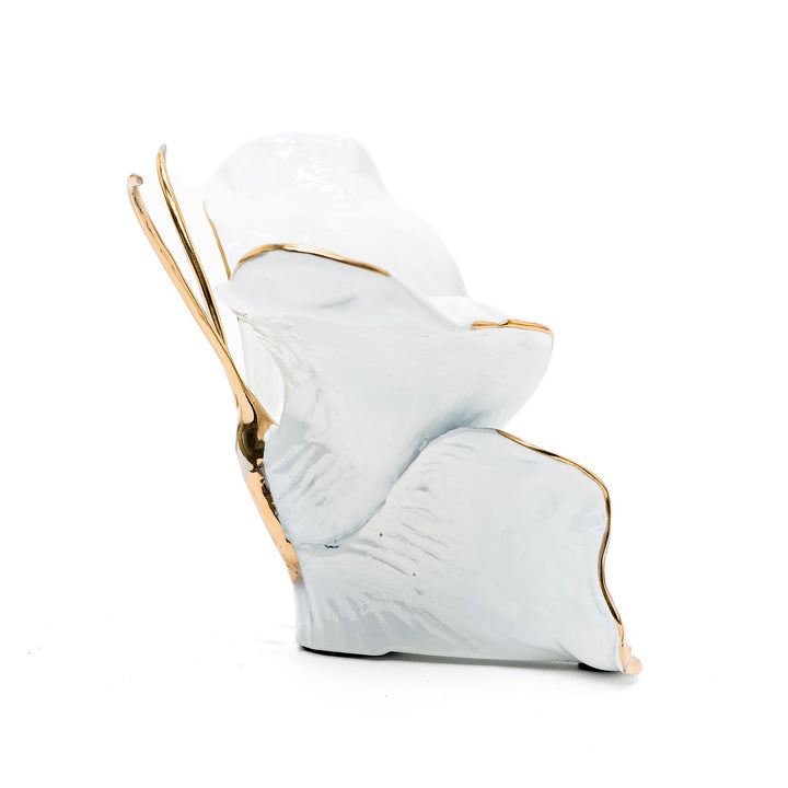 Glossy white butterfly with gold accents and sculpted form