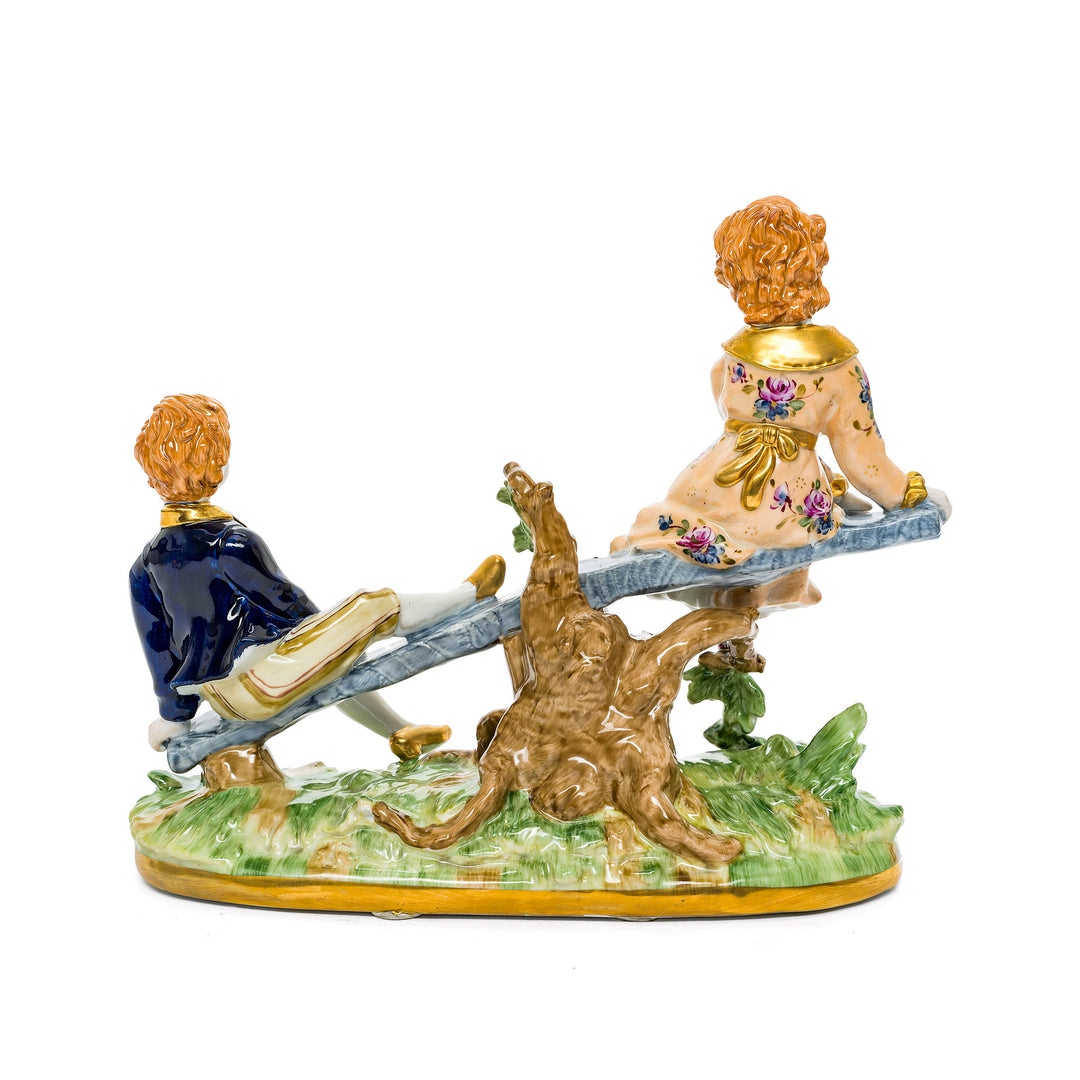 Hand-crafted Seesaw Children German porcelain figurine with delicate details.