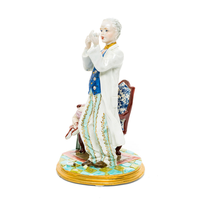 Hand-painted porcelain figurine of a doctor and a reluctant patient, crafted in fine German porcelain.