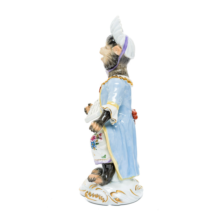 Hand-painted porcelain figurine of a musical monkey maestro, crafted from fine German porcelain.