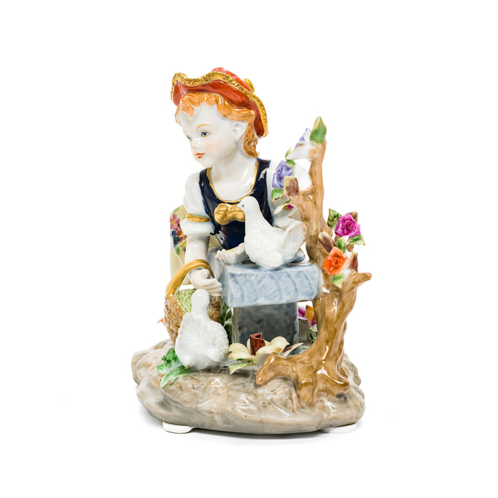 Hand-painted porcelain figurine of a young girl with doves, crafted in fine German porcelain.