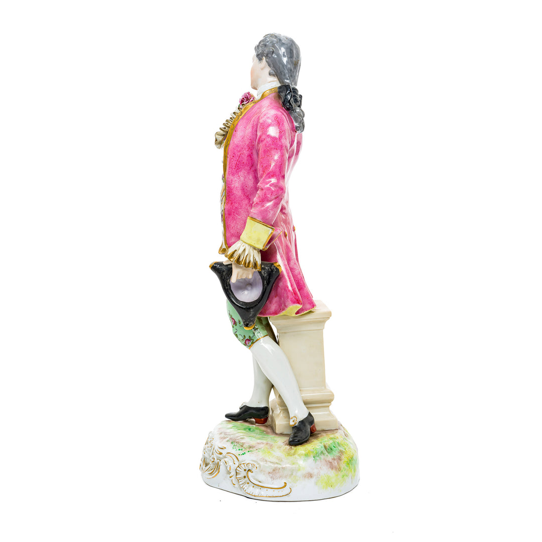 Hand-painted porcelain figurine of a Rococo-era gentleman in floral attire, crafted from fine German porcelain.