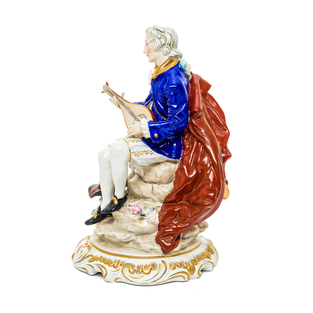 Hand-painted porcelain figurine of a nobleman playing a lute, crafted in fine German porcelain.