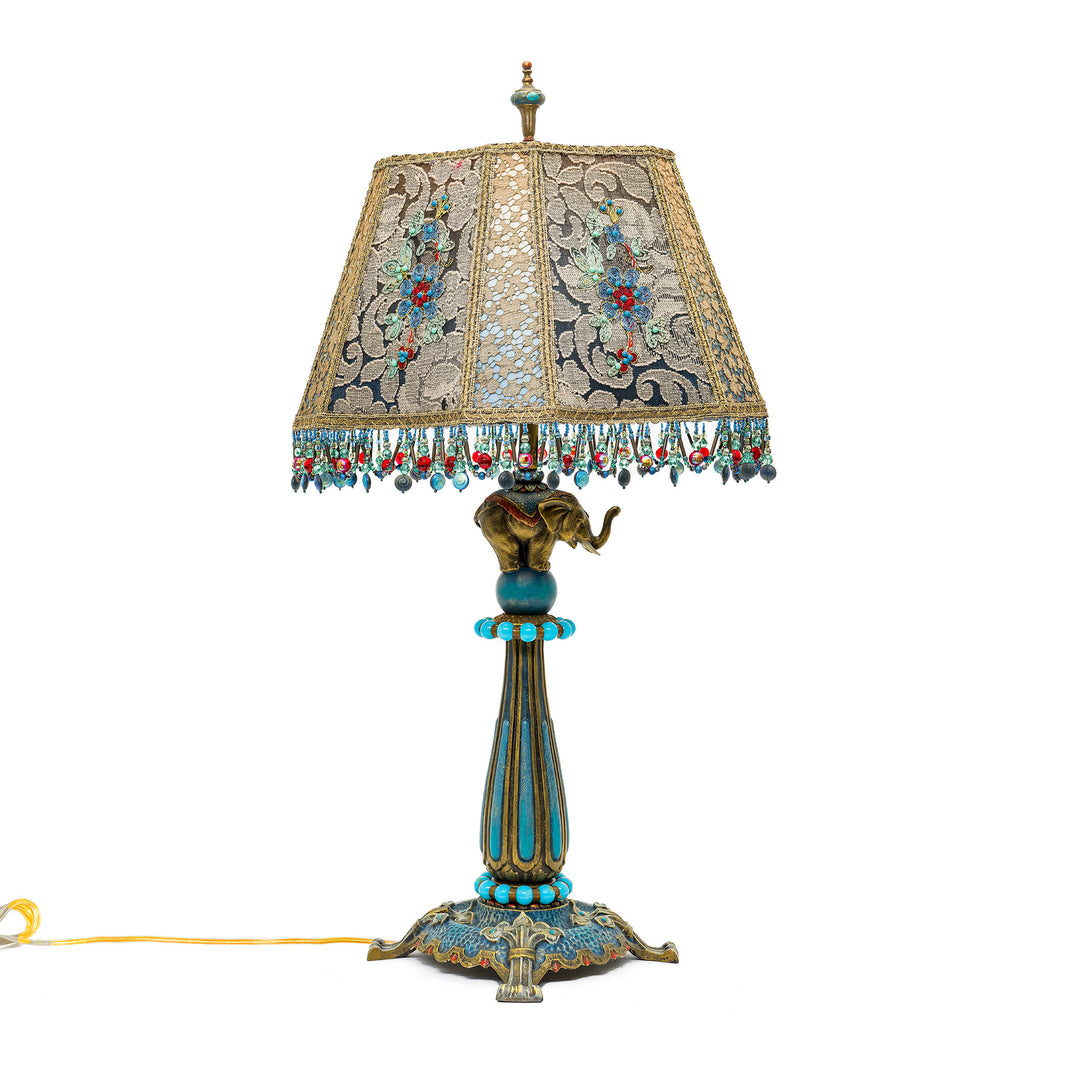 Handcrafted bronze lamp with intricate floral embroidery