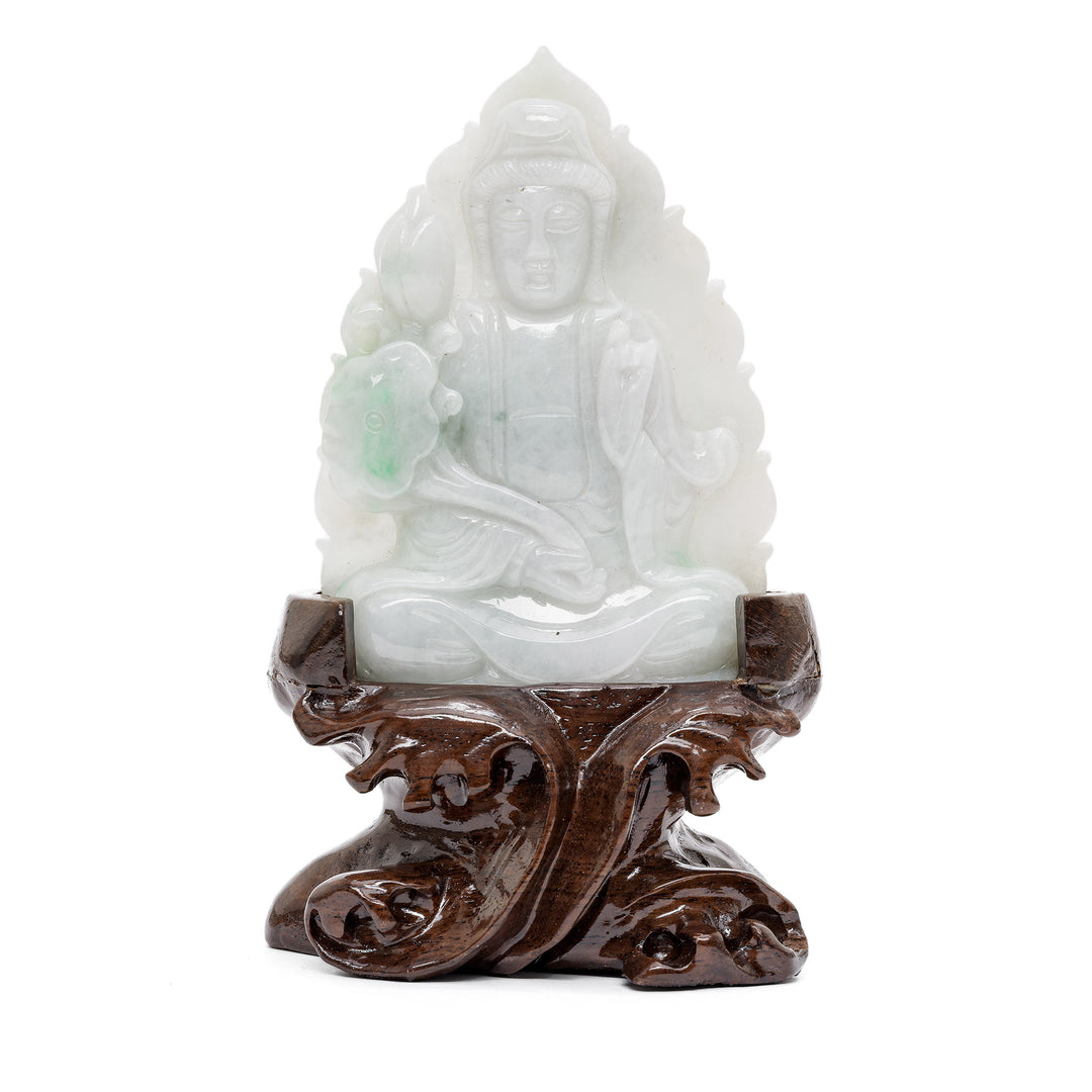 Jade Guan Yin sculpture in front of lotus flower