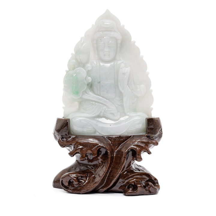 Jade Guan Yin sculpture in front of lotus flower