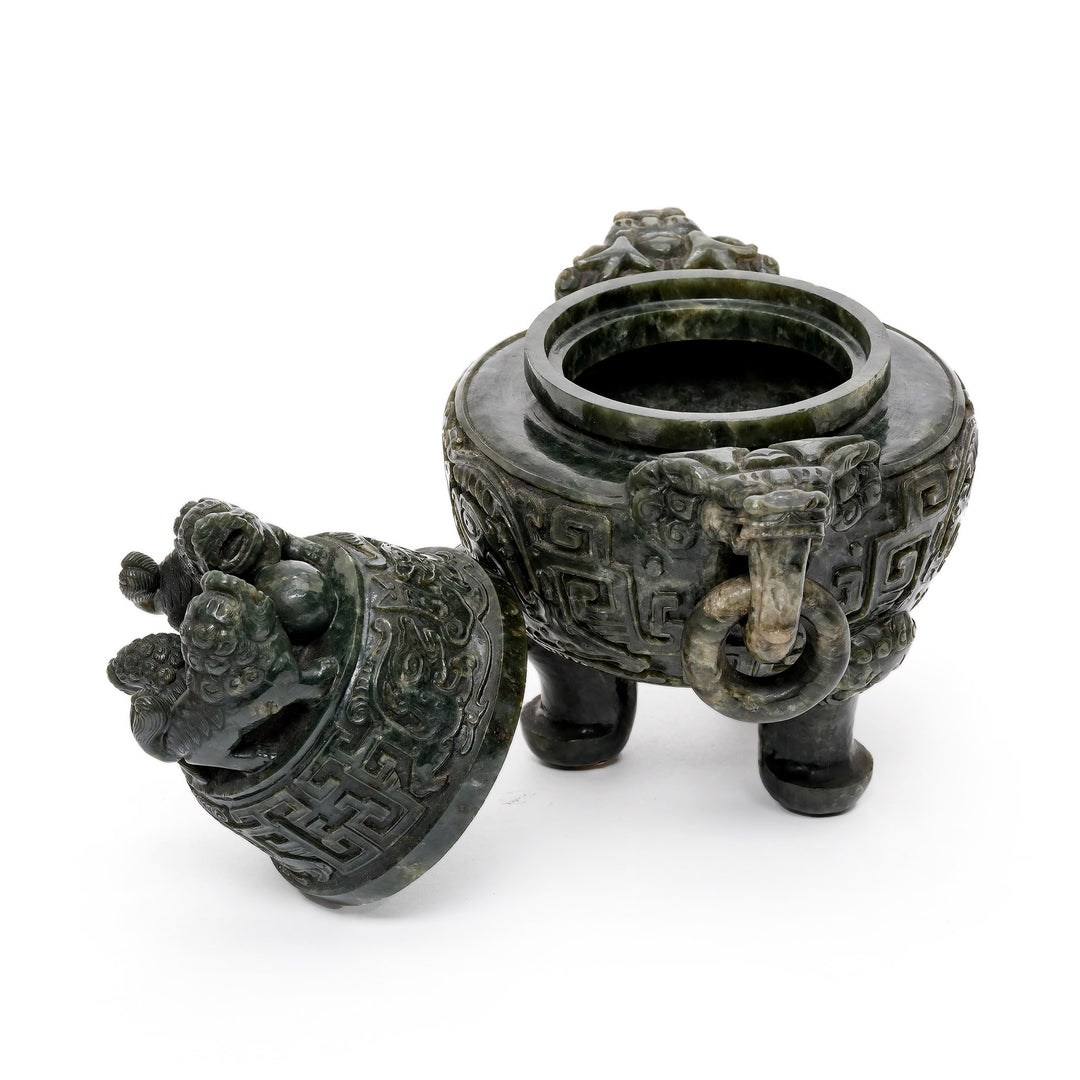 Side profile of green jade burner showcasing ornate carvings