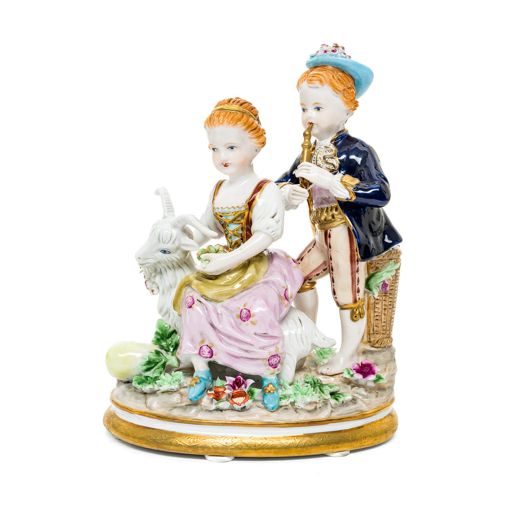 Melodies in the Meadow German porcelain figurine featuring two children enjoying music in a pastoral scene.