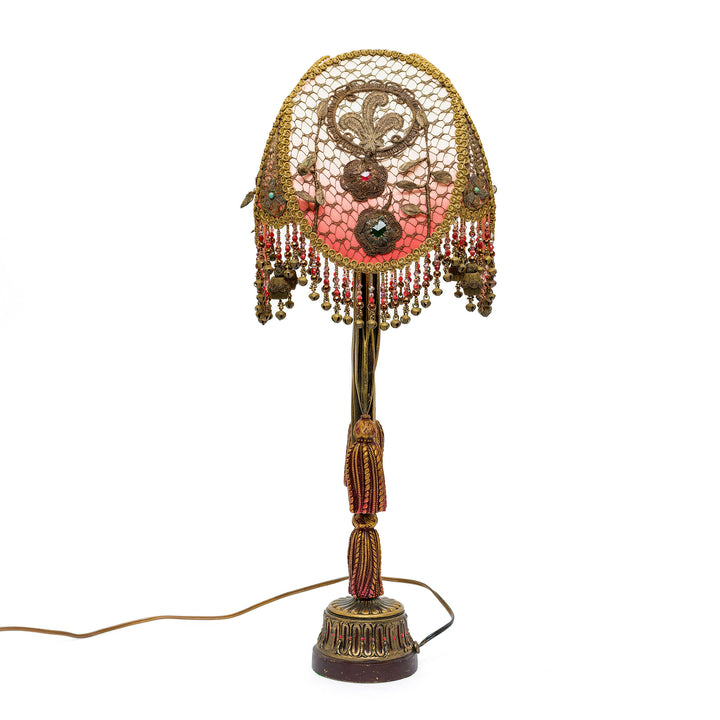 Decorative lamp with intricate design on a white background