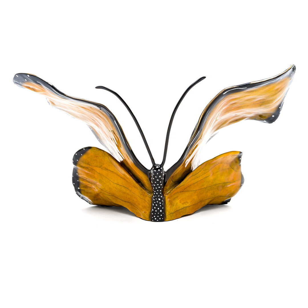 Rear angle of butterfly sculpture with spread wings and dotted accents