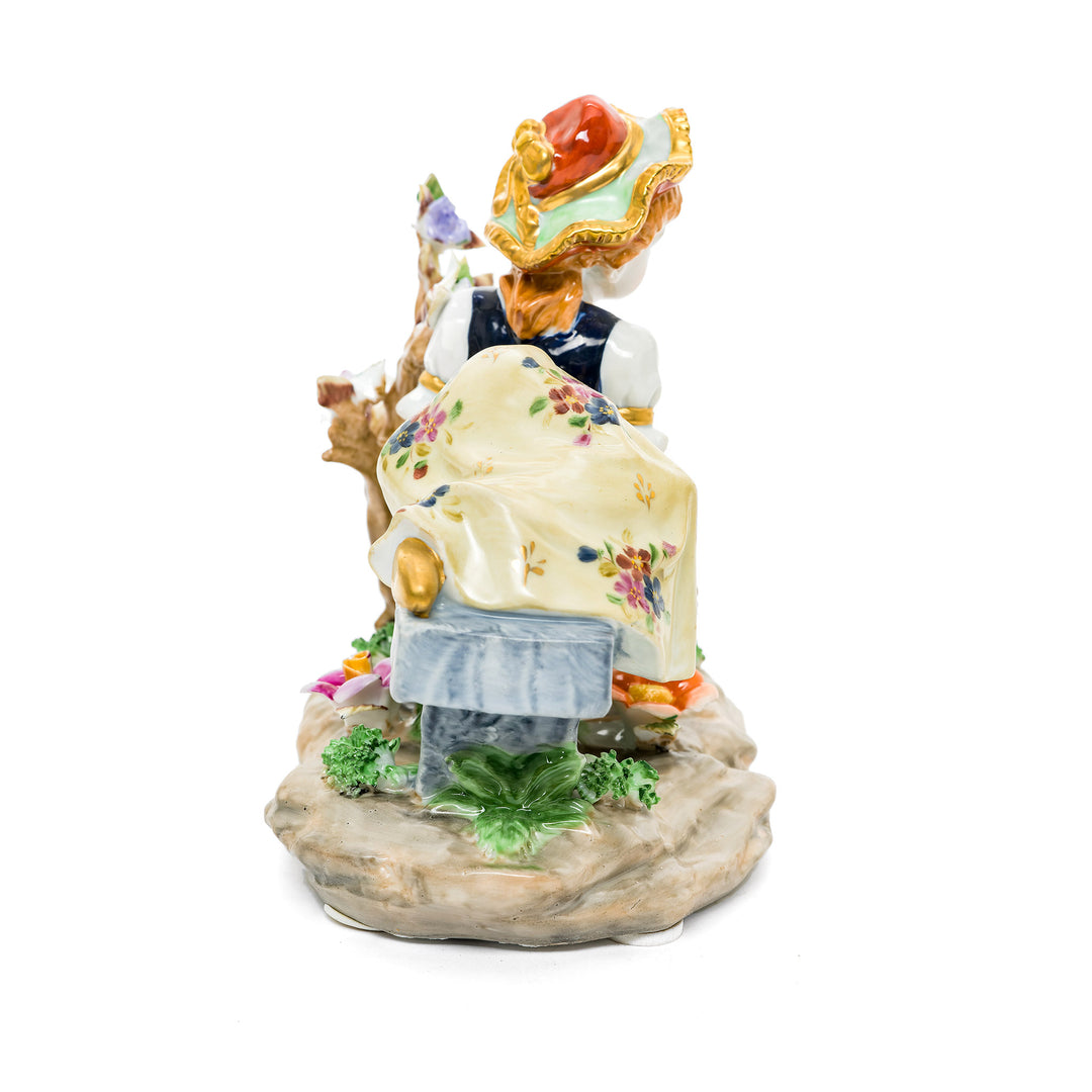 Porcelain figurine featuring gentle moments of a young girl interacting with doves, made from fine German porcelain.