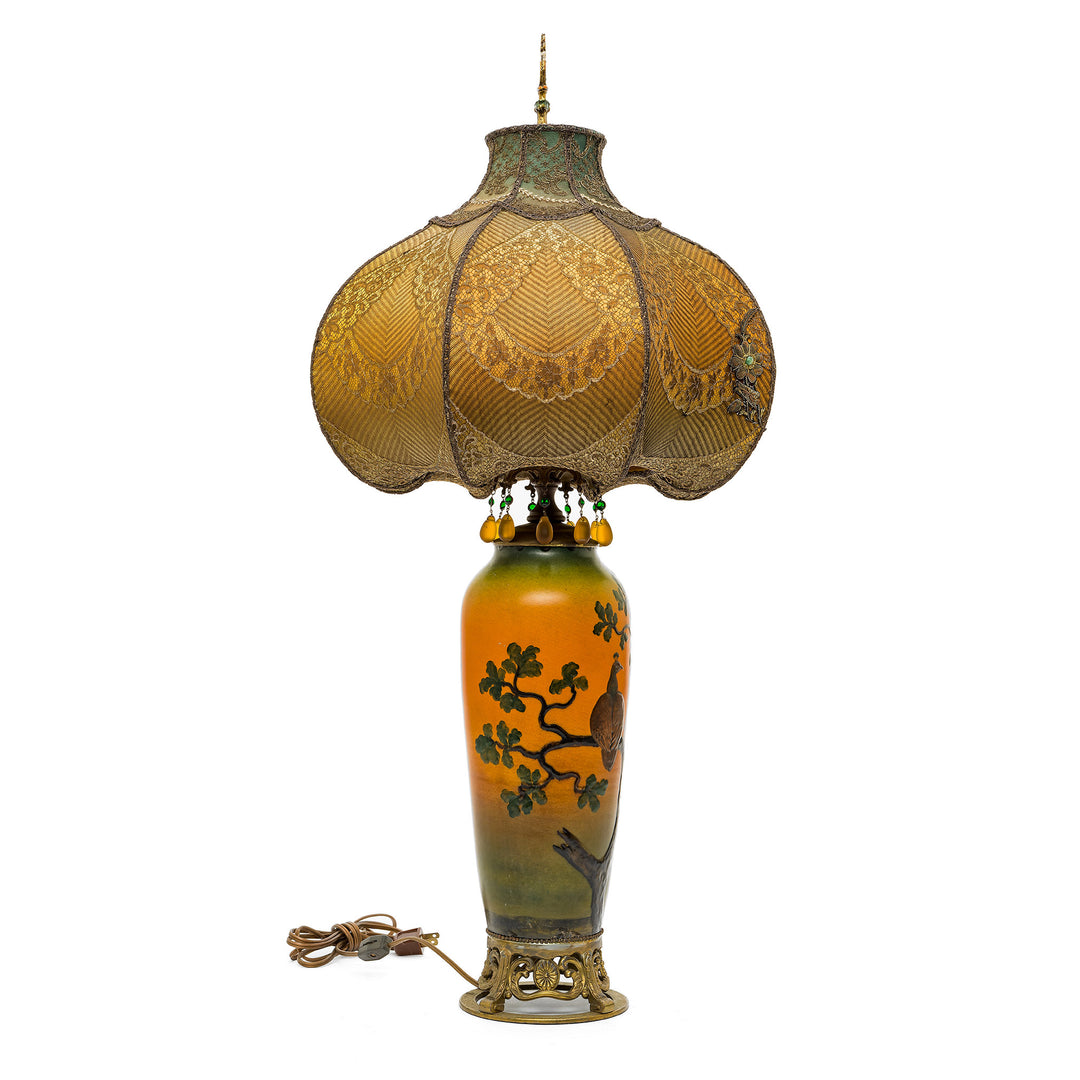 Ornate Victorian-style lamp with luxurious textile and beadwork