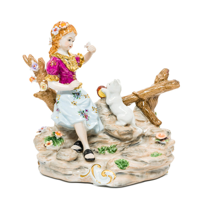 Playful Bond with the Kitten German porcelain figurine featuring a young girl and her playful kitten.