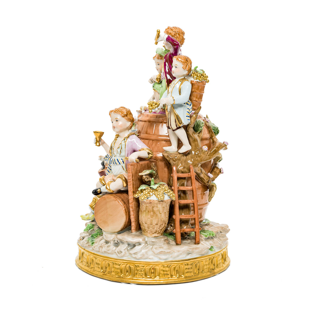 Playful German porcelain figurine of a winemakers family scene with children enjoying the process.