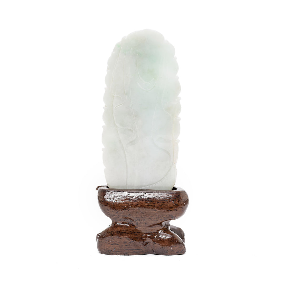 Rear view of jade Guan Yin sculpture on wood base