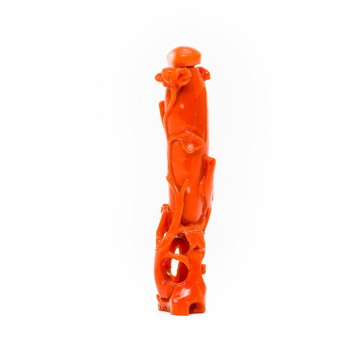 Side view of red-orange coral snuff bottle with floral designs