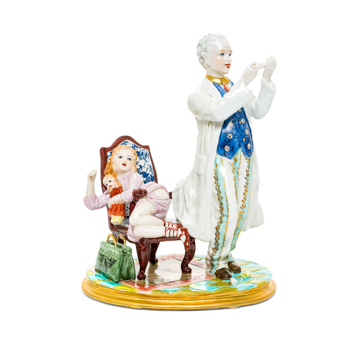 The Reluctant Patient German porcelain figurine depicting a humorous scene of a doctor and a hesitant patient.