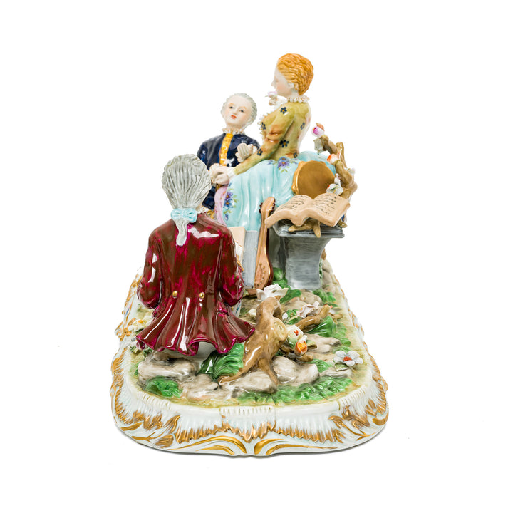 Romantic German porcelain figurine featuring a courting trio with vibrant colors and intricate details.